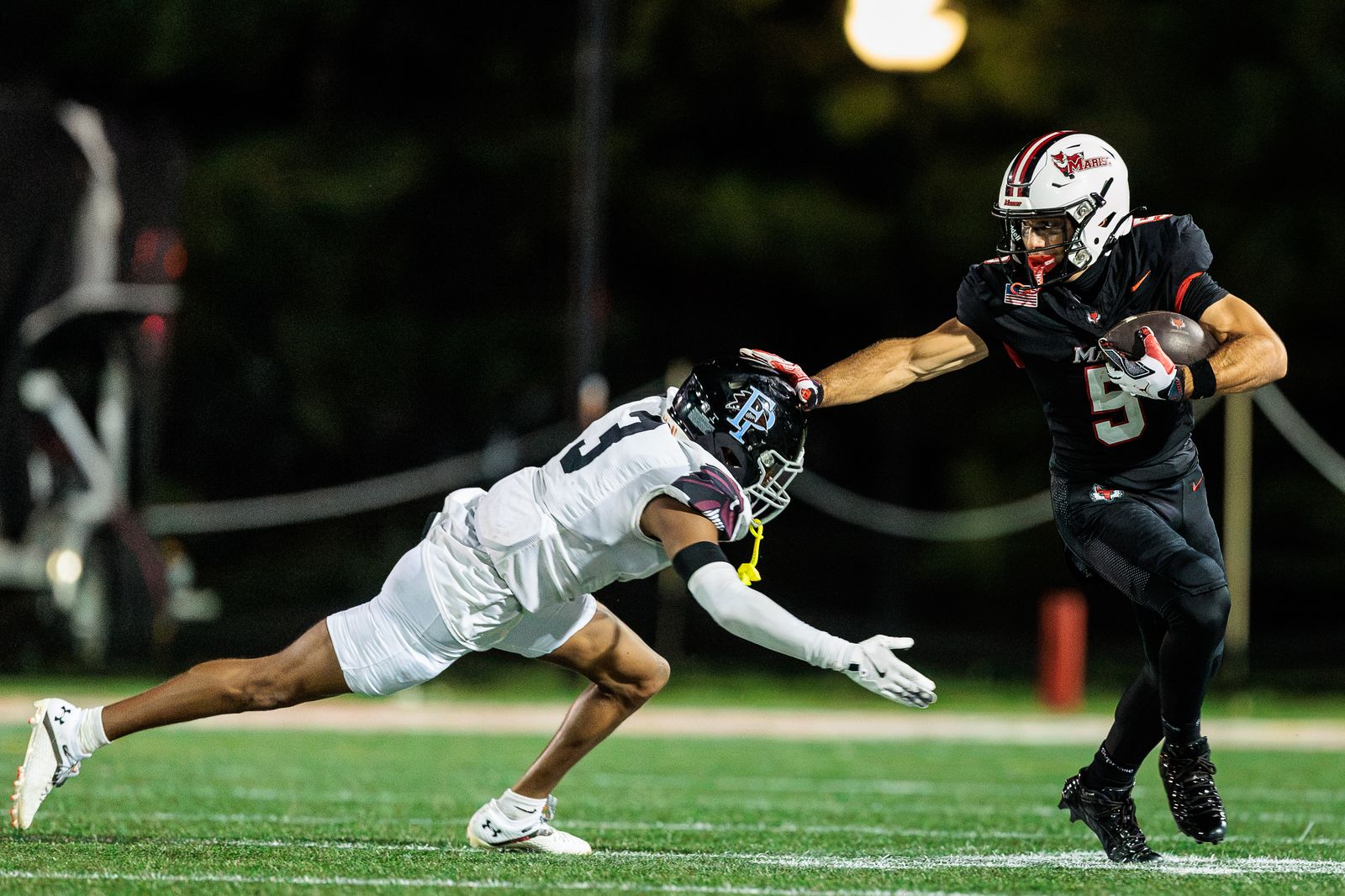 Football: Marist runner stiff-arms a Franklin Pierce defender — photographed by Michael LaCroix-Fralish for 845 Sports Rewind