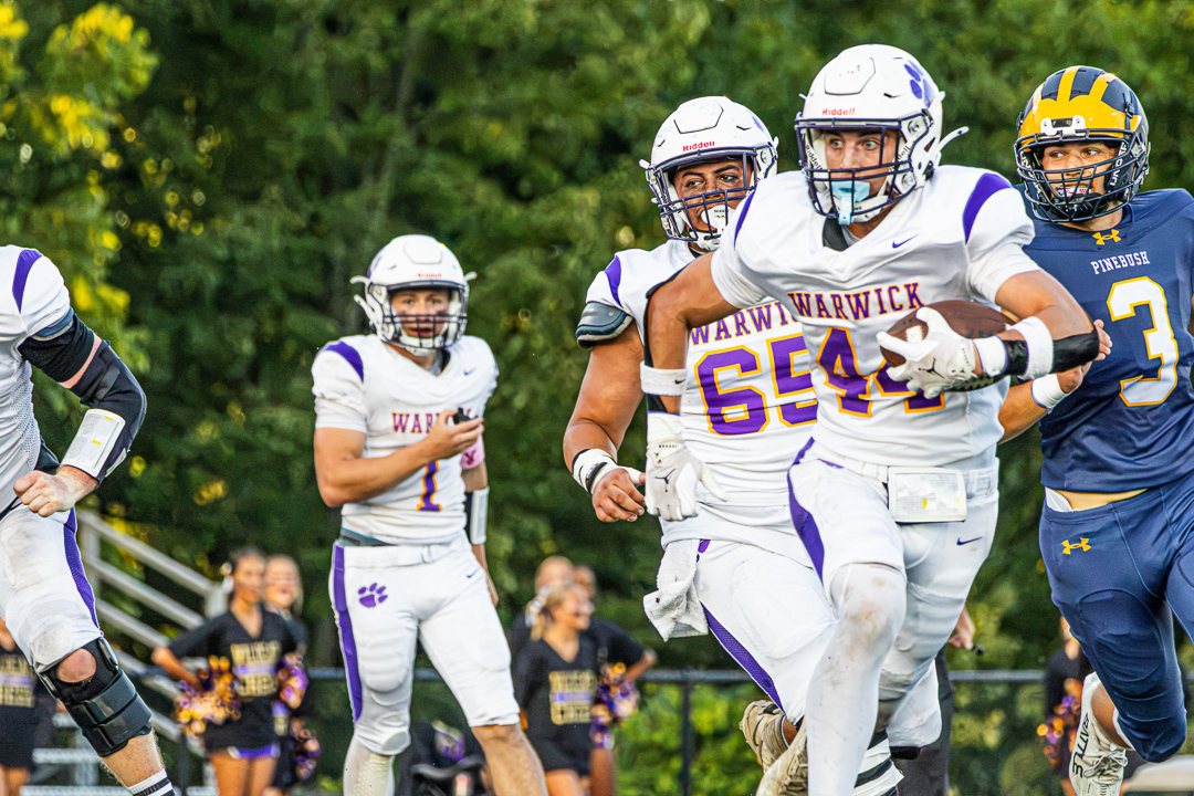 Football: A Warwick ball carrier runs past Pine Bush defenders &mdash; photographed by Chase Plowden for 845 Sports Rewind