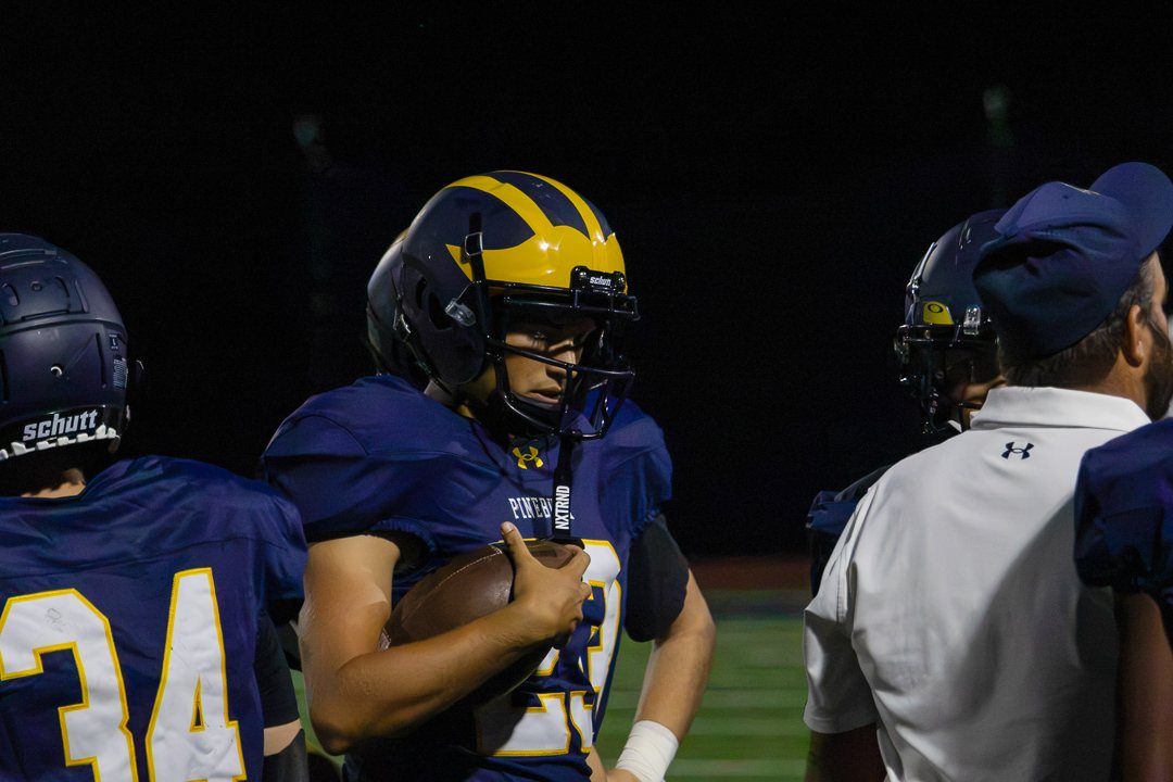 Football: A Pine Bush player holds the football on the sideline against Warwick — photographed by Chase Plowden for 845 Sports Rewind