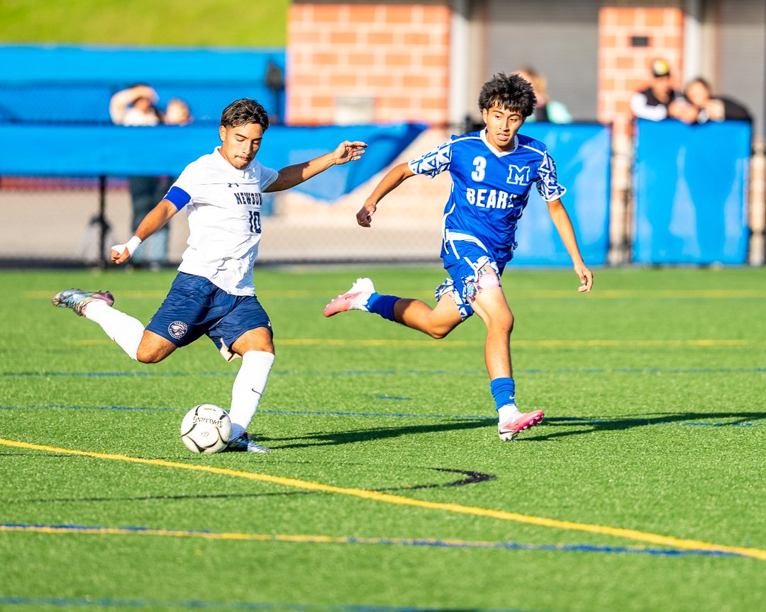 Boys soccer: A Newburgh attacker strikes the ball past a Middletown defender &mdash; photographed by 845 Sports Rewind Staff