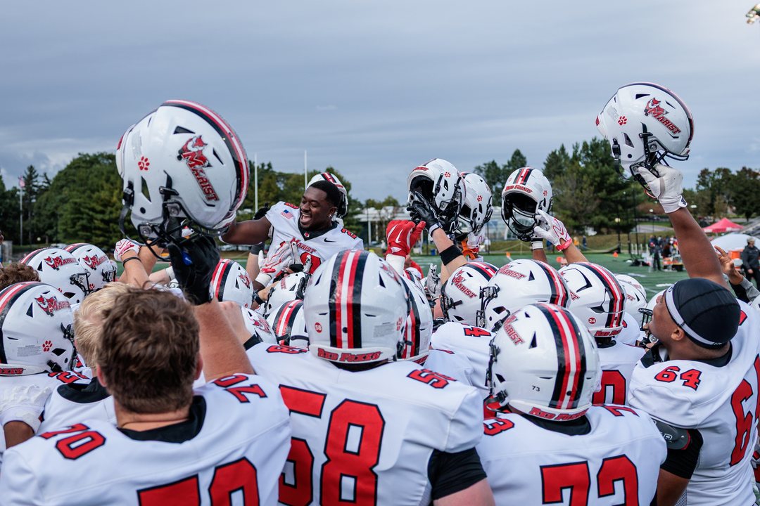 Football: Marist players raise their helmets in a team huddle at Tenney Stadium — photographed by Michael LaCroix-Fralish for 845 Sports Rewind
