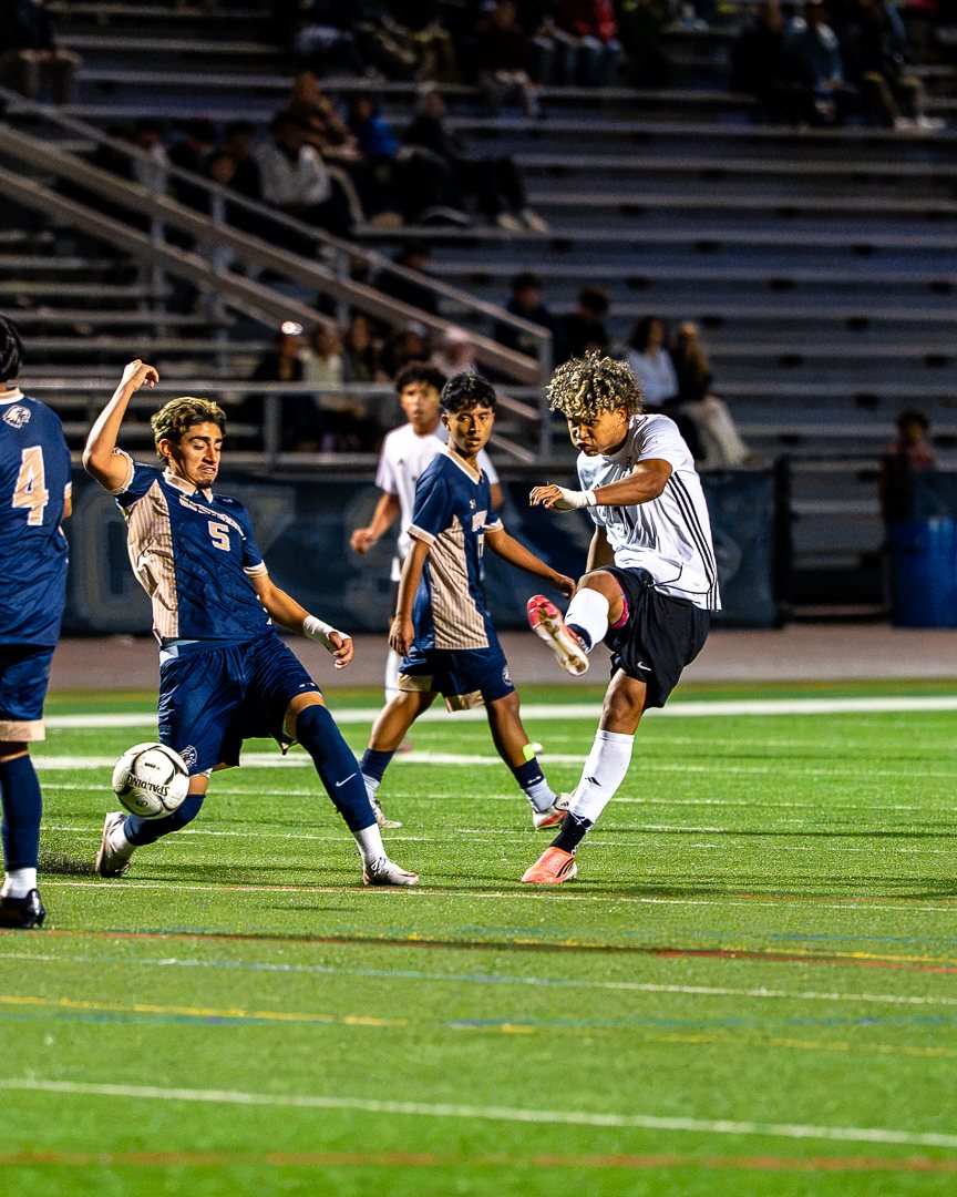 Boys soccer: A Monroe-Woodbury player fires a shot past a sliding Newburgh Free Academy defender — 845 Sports Rewind staff photo