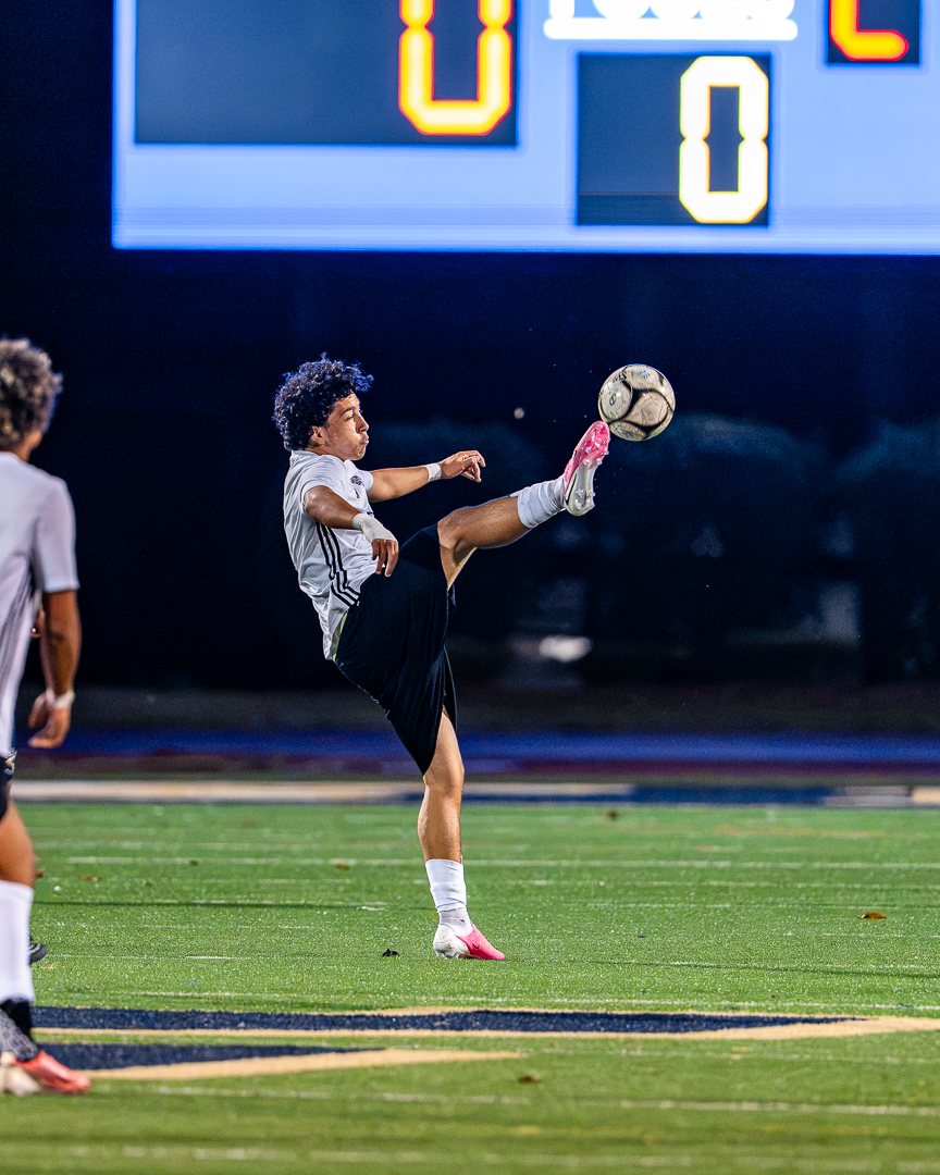 Boys soccer: A Monroe-Woodbury player volleys the ball in front of the scoreboard at Newburgh Free Academy &mdash; 845 Sports Rewind staff photo
